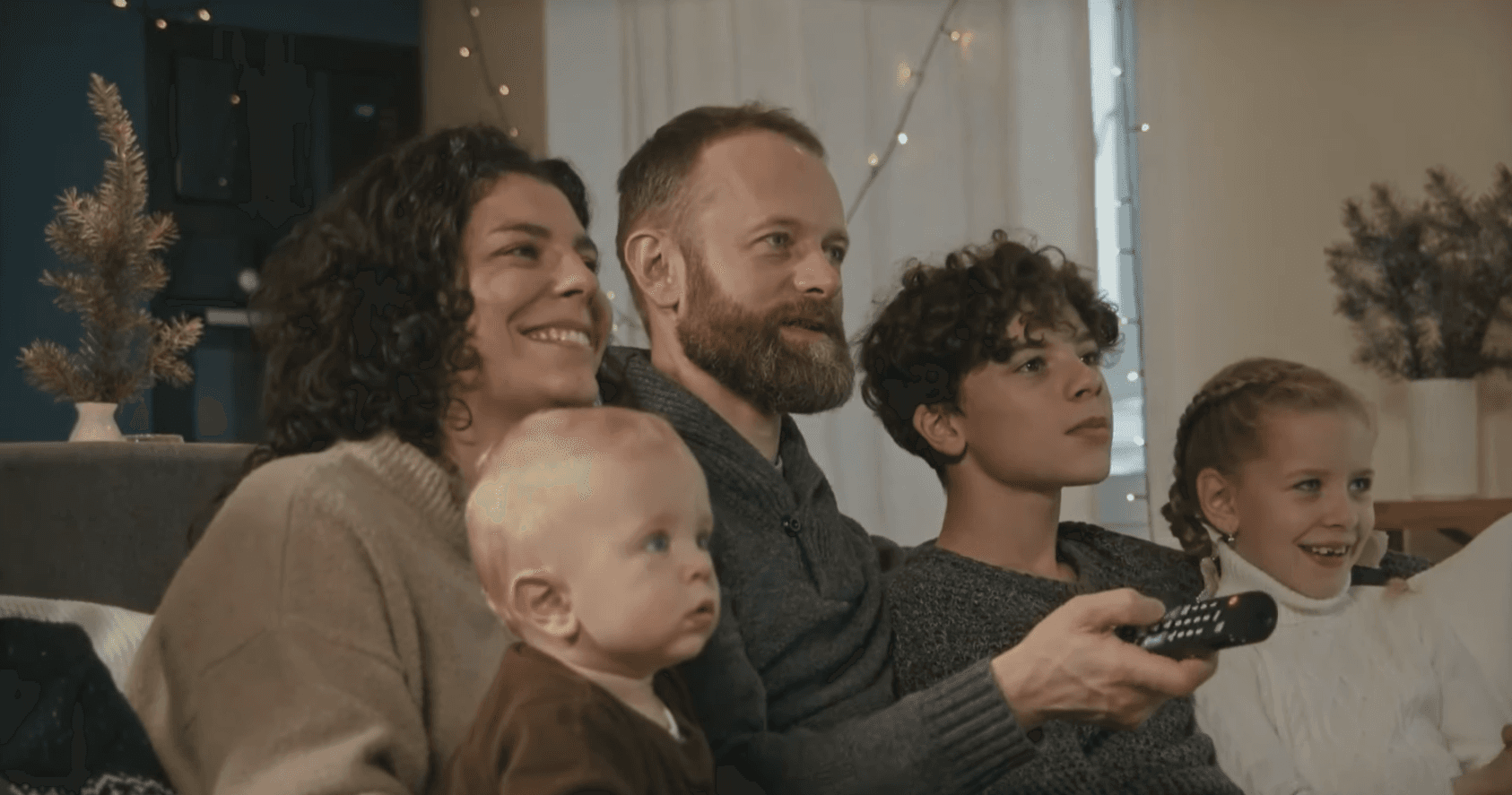 A family enjoying their memories together on television